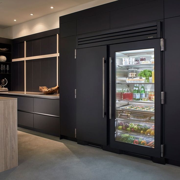 A black refrigerator with grocery items