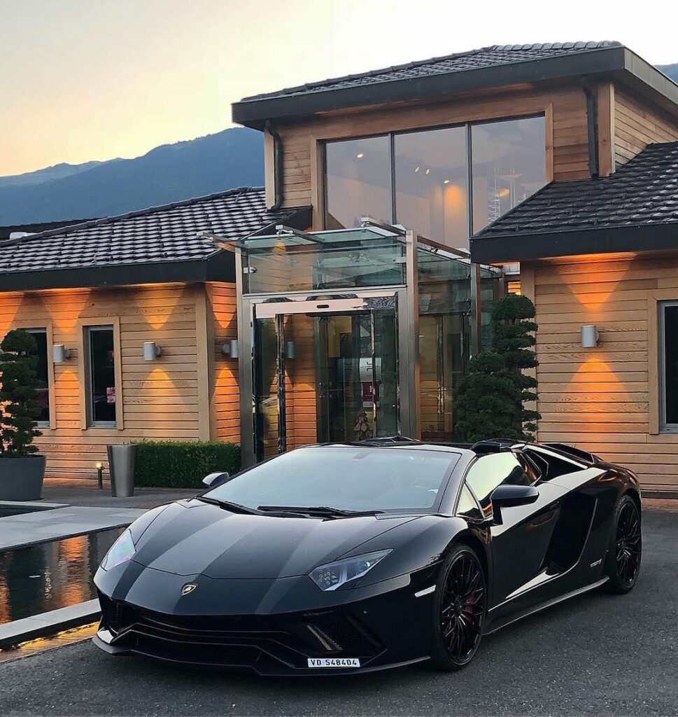 A luxury car outside of a modern property