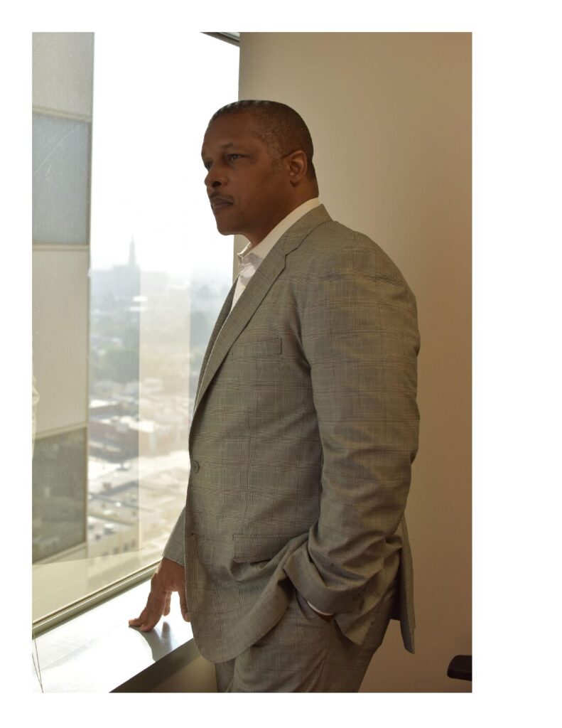 A black man wearing a gray formal attire