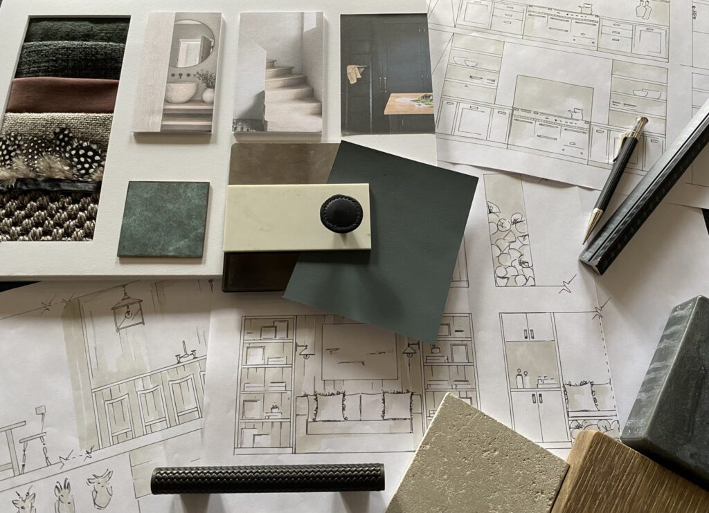 A collection of furniture and design tools on a table.