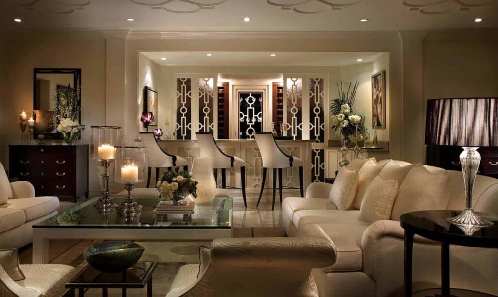 A living room with white furniture and a chandelier.