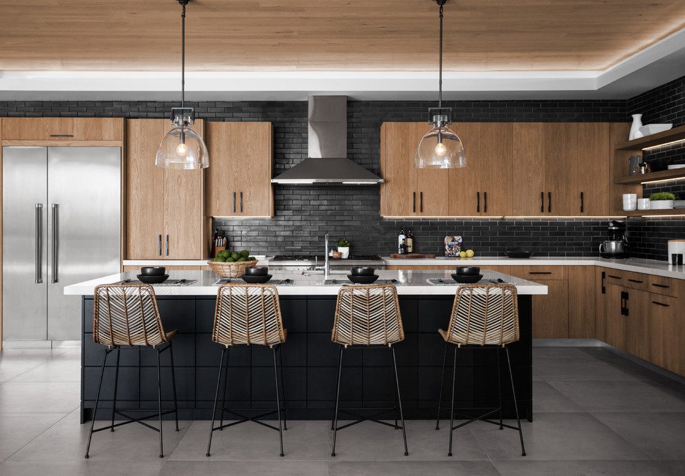 A modern kitchen with black and wood cabinets.