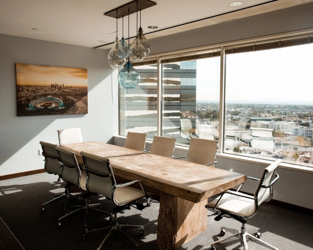 A conference room with a large window overlooking a city.